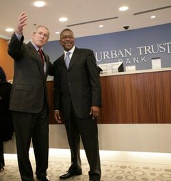 President George W. Bush is welcomed by Bob Johnson, founder and chairman of the RLJ Companies.jpg