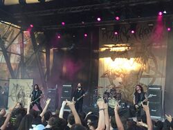 A photograph of the band Rotting Christ performing in 2015