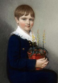 Three quarter length portrait of seated boy smiling and looking at the viewer; he has straight mid-brown hair and wears dark clothes with a large frilly white collar; in his lap he holds a pot of flowering plants