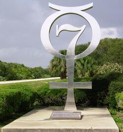 Silver memorial in the form of a combined 7 and Mercury symbol