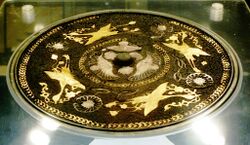 Mirror with laquered back inlaid with 4 phoenixes holding ribbons in their mouths. Tang Dynasty. Eastern Xi'an city.jpg