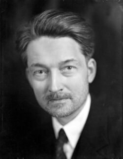A black-and-white photo of Maritain looking toward the camera
