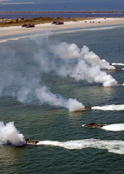 US Navy 090425-N-4879G-393 A group of multinational amphibious assault vehicles from the amphibious dock landing ship USS Ashland (LSD 48) deploy smoke to cover their landing during a simulated amphibious landing demonstration.jpg