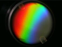 Photo of a circular dish containing a rainbow like pattern.