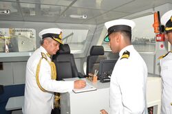 Vice Admiral Satish Soni signing the visitor's book the commissioning ceremony of Immediate Support Vessels T-38, T-39 & T-40.jpg