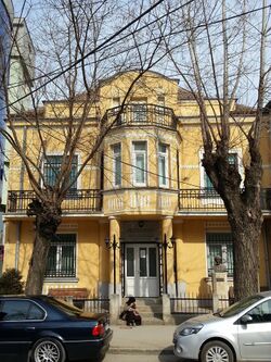 Two-story building on a tree-lined street