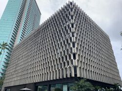 The IBM Building in Honolulu, seen from the corner. The building is covered in a concrete grid or lattice pattern.