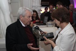 Photograph of Predrag Matvejević talking to a woman holding a tape recorder
