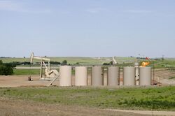 Orvis State oil well and gas tanks and natural gas flare - Evanson Place - Arnegard North Dakota - 2013-07-04 (9287569795).jpg