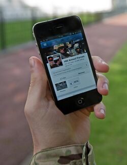 A serviceman accesses social media channels using a smart phone, outside MOD Main Building in London MOD 45156046.jpg