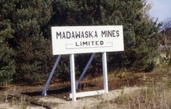 Wooden white sign with "MADAWASKA MINES LIMITED"