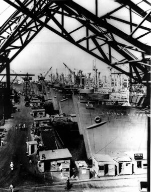Victory cargo ships are lined up at a U.S. west coast shipyard.jpg