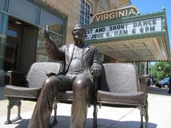 An image of a bronze statue of Roger Ebert outside of a movie theater.