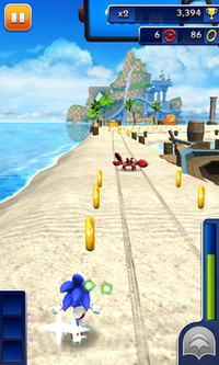 Sonic the Hedgehog collecting rings in the left lane of a road on a beach