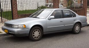 1989 Nissan Maxima in Blueish Silver, front left (Queens Village).jpg