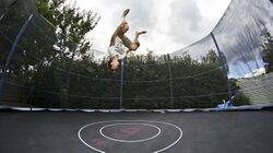 Jumper doing flip on trampoline with safety net, 2012.jpg