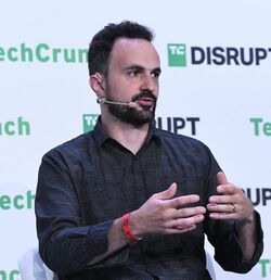 Marczak speaking while gesturing with hands during TechCrunch Disrupt panel discussion