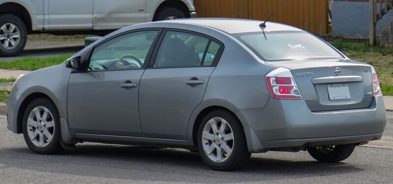 File:2009 Nissan Sentra FE+ 2.0 SL in Magnetic Gray, Rear Left, 04-28-2023.jpg