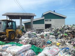 Photograph of piles of trash including large amounts of plastic at an incinerator