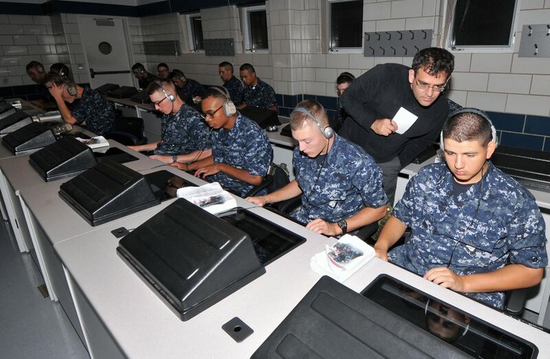 File:US Navy 100916-N-8848T-351 Dr. Talib Hussain, senior scientist at BBN Technologies, looks over the shoulder of a recruit during a training session.jpg