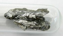 Two dull silver clusters of crystalline shards.