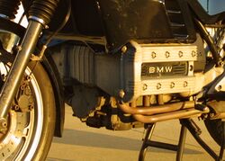 Closeup picture of BMW K100 engine. Also shows some black bodywork, forks and a front brake caliper