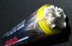 Potassium carbonate, formed from the hydroxide solution leaking from an alkaline battery