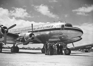 Four-engined civil airliner on airfield, bearing the legend "Trans Australia Airlines"