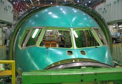 Close up view of a green Section 41, the nose section of a 767. Installation is not yet complete for the window panes.