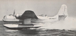 A seaplane kicks up an impressive plume of spray during takeoff.