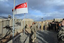 Flag lowering by Singapore troops, Kiwi Base, Bamyan Province, Afghanistan - 20101027.jpg