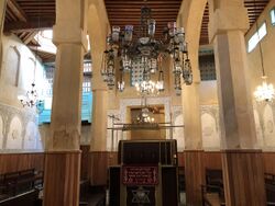 Interior of the Al Fassiyin Synagogue showing pillars and a chandelier