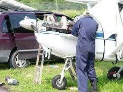 Field maintenance on a 1956 model Cessna 172.JPG