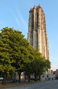 An ornate stone brick bell tower in Mechelen, Belgium