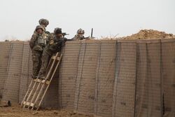 U.S. Soldiers and Afghan soldiers provide security while standing behind HESCO barriers during strongpoint construction at Zharay district, Kandahar province, Afghanistan, Feb 120210-A-QD683-134.jpg