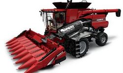 Case IH 7140 rotary harvester with corn front with cutaway showing rotary threshing mechanism.jpg