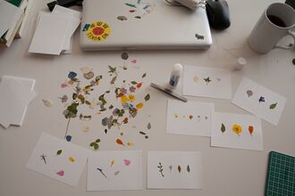 Dried flowers and cards on a desk