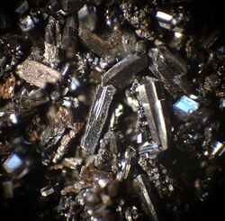 a haphazard aggregate of brownish crystals