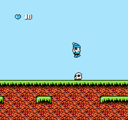 Screenshot from the game's first area: Bop-Louie (the player) is shown, jumping on a Teketeke, one of the main enemies in the game.