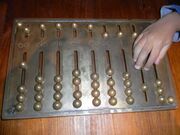 HK TST Science Museum exhitit - Rome Abacus with hand Jan-2013.JPG