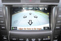 Rear camera view showing street on a car screen.