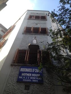 Three-story building with a sign and a statue
