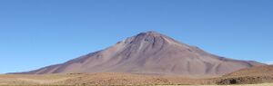 A brown mountain in a barren landscape