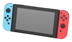 The Nintendo Switch in handheld mode. The center tablet is black, and attached on both sides are Joy-Con controllers. The left Joy-Con is blue, with several buttons. The right Joy-Con is red, with several other buttons.