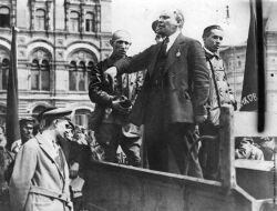 Lenin making a speech from the back of a vehicle before troops in the Red Square, 1919