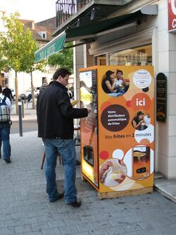 Side view of a Just Fries brand vending machine in Valenciennes, France (2008)