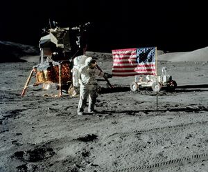 The first image is a successful moon landing in full color containing the American flag, an astronaut, a lunar rover, and a lunar landing module. The second image is an emblem containing a statue of the Greek god Apollo, red stripes inside an eagle made of white lines, the Moon, Saturn, and a spiral galaxy; along the outside of the emblem are is the word "Apollo" along with the number "seventeen" in roman numerals, and then the name "Cernan," "Evans," and "Schmitt." The third and final image contains Schmitt on the left, Cernan in the middle and sitting, and Evans behind Cernan.
