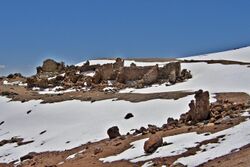 Photo of a dilapidated building in a barren, snow-covered landscape