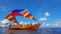 Balangay boat with Philippine flag.jpg