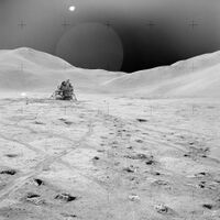 A lunar landscape with a lander in the background